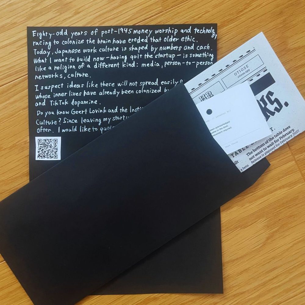 Internal HR bulletin, desk charm, and black envelope — as shipped